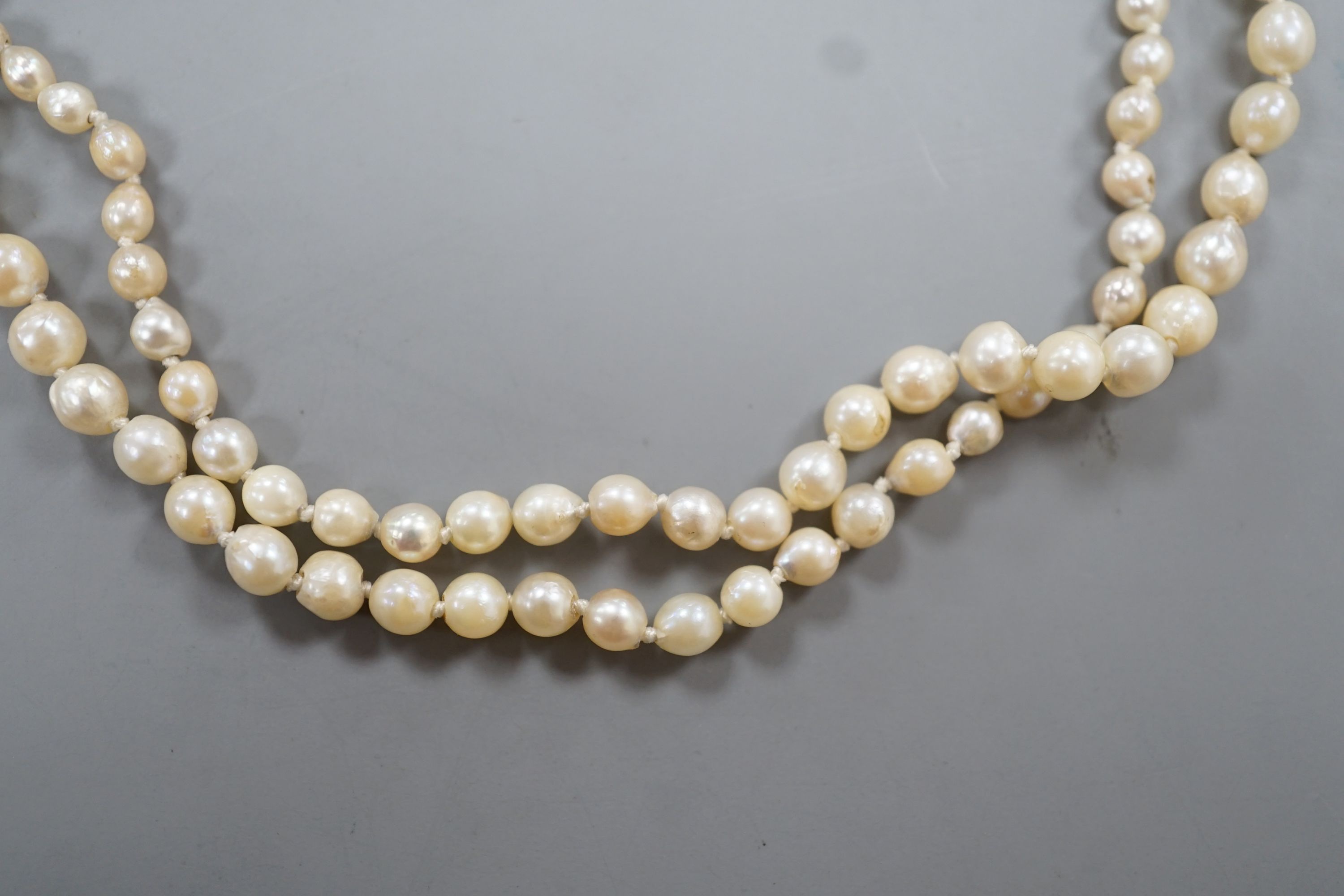 A single strand graduated cultured pearl necklace, with diamond chip set white metal clasp, 54cm, gross weight 13 grams.